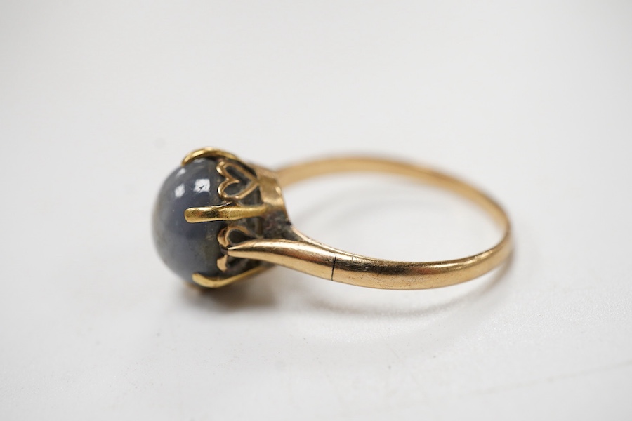A yellow metal and single stone claw set star sapphire ring, size P, the stone approx. 9mm in diameter.